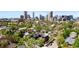 Aerial view of a vibrant city neighborhood with tree-lined streets and modern homes against a skyline backdrop at 2355 N Emerson St, Denver, CO 80205