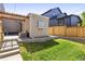 Landscaped backyard featuring a patio, small lawn, and pergola, perfect for outdoor relaxation and entertaining at 2355 N Emerson St, Denver, CO 80205