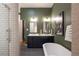 Stylish bathroom featuring dual vanity, a soaking tub, a separate shower, and contemporary fixtures at 2355 N Emerson St, Denver, CO 80205