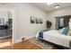 Bright bedroom with hardwood floors, a skylight, and access to a bathroom via a sliding barn door at 2355 N Emerson St, Denver, CO 80205