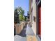 View of a shady, covered front porch with seating and outdoor plants at 2355 N Emerson St, Denver, CO 80205