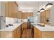 Modern kitchen featuring stainless steel appliances, quartz countertops, and a large island with bar seating at 2355 N Emerson St, Denver, CO 80205
