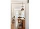 Open-concept view of kitchen with bar stool seating, hardwood floors, and natural light at 2355 N Emerson St, Denver, CO 80205