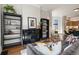 Comfortable living room showcasing a decorative fireplace, bookshelves, and seamless transition to dining at 2355 N Emerson St, Denver, CO 80205