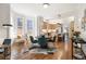 Open floor plan featuring a living room connected to the kitchen and dining area with natural light at 2355 N Emerson St, Denver, CO 80205