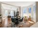 Bright living room featuring hardwood floors, large windows, and an elegant dining table at 2355 N Emerson St, Denver, CO 80205