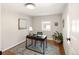 Bright office space with hardwood floors, a modern desk, and a large window at 2355 N Emerson St, Denver, CO 80205