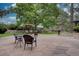 Expansive backyard with a dining set, cozy swing, fire pit, and mature trees creating a serene outdoor retreat at 7715 S Hudson Ct, Centennial, CO 80122