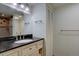 Traditional bathroom features a granite countertop, vanity with storage, and shower stall with brown tiles at 7715 S Hudson Ct, Centennial, CO 80122
