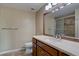 Bathroom featuring a vanity with marble countertop, tiled shower, and framed mirror at 7715 S Hudson Ct, Centennial, CO 80122