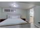 Bedroom featuring a queen bed and bathroom access at 7715 S Hudson Ct, Centennial, CO 80122