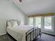 Bedroom with queen bed, ceiling fan, and three windows with natural light at 7715 S Hudson Ct, Centennial, CO 80122
