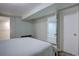 Bedroom featuring a queen bed and door access at 7715 S Hudson Ct, Centennial, CO 80122