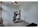 Home gym area with elliptical, ceiling fan, and open floor plan at 7715 S Hudson Ct, Centennial, CO 80122