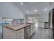 Open concept kitchen with stainless steel appliances, light cabinetry, and a large center island with seating at 7715 S Hudson Ct, Centennial, CO 80122