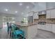Bright kitchen features stainless steel appliances, a large island with seating, and lots of natural light at 7715 S Hudson Ct, Centennial, CO 80122
