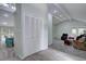 Spacious living room featuring vaulted ceilings, carpet, and access to dining and other living spaces at 7715 S Hudson Ct, Centennial, CO 80122