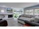 Cozy living room with a brick fireplace, large sectional sofa, and lots of natural light at 7715 S Hudson Ct, Centennial, CO 80122