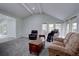 Spacious living room featuring vaulted ceilings, carpet, and large windows for lots of natural light at 7715 S Hudson Ct, Centennial, CO 80122