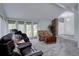 Open concept living room featuring vaulted ceilings, carpet, stone accent wall, and access to entry at 7715 S Hudson Ct, Centennial, CO 80122