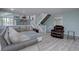Comfortable living room with stairs, views of the kitchen, and natural light at 7715 S Hudson Ct, Centennial, CO 80122