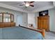 Comfortable main bedroom featuring a ceiling fan, TV, and ensuite bathroom at 7715 S Hudson Ct, Centennial, CO 80122