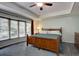 Bedroom featuring a large bed, a ceiling fan, neutral walls, and a large window at 7715 S Hudson Ct, Centennial, CO 80122