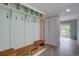 Hallway offers coat racks, cubbies, bench seating, and storage; neutral walls, wood-look flooring at 7715 S Hudson Ct, Centennial, CO 80122