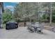 Outdoor patio featuring a grill, dining table with chairs, and lush greenery creating an inviting space for gatherings at 7715 S Hudson Ct, Centennial, CO 80122