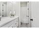 Clean bathroom with white cabinets, a shower-tub combo, and modern fixtures at 21894 E Tufts Cir, Aurora, CO 80015