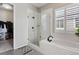 Bathroom with a glass shower, soaking tub, and black fixtures at 21894 E Tufts Cir, Aurora, CO 80015