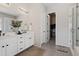 Bathroom featuring double sinks, white cabinets, and access to walk-in closet at 21894 E Tufts Cir, Aurora, CO 80015