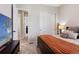 Comfortable bedroom with neutral carpet, a large bed, and an adjacent closet at 21894 E Tufts Cir, Aurora, CO 80015