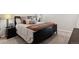 Relaxing bedroom with neutral carpet, a large bed, and bedside lamps at 21894 E Tufts Cir, Aurora, CO 80015