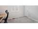 A bright bedroom featuring carpeted floors and a window with white shutters at 21894 E Tufts Cir, Aurora, CO 80015