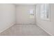 Cozy bedroom with neutral carpet, a window with blinds, and ample natural light at 21894 E Tufts Cir, Aurora, CO 80015