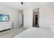 Bedroom with carpeted floors, white dresser, and access to walk-in closet at 21894 E Tufts Cir, Aurora, CO 80015