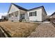 Home with a covered patio, sliding glass doors, a lawn and gravel landscaping at 21894 E Tufts Cir, Aurora, CO 80015
