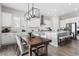 Bright kitchen features white cabinets, stainless steel appliances, and an island with bar seating at 21894 E Tufts Cir, Aurora, CO 80015