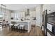 Modern kitchen featuring white cabinetry, stainless steel appliances, and a center island with seating at 21894 E Tufts Cir, Aurora, CO 80015