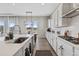 Bright kitchen with stainless appliances, quartz countertops, and a view to the outside living area at 21894 E Tufts Cir, Aurora, CO 80015