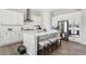 Well-equipped kitchen with stainless steel appliances, a large island, and white subway tile backsplash at 21894 E Tufts Cir, Aurora, CO 80015