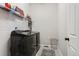 Functional laundry room with modern washer and dryer and wire shelving for storage at 21894 E Tufts Cir, Aurora, CO 80015