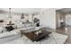 Spacious living room with a comfortable sofa, adjacent to a modern kitchen and dining area at 21894 E Tufts Cir, Aurora, CO 80015