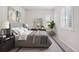 Comfortable main bedroom with a large bed, neutral decor, and a window with blinds at 21894 E Tufts Cir, Aurora, CO 80015