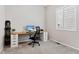 Bright home office with a modern desk, stylish black chair, and natural light from window at 21894 E Tufts Cir, Aurora, CO 80015