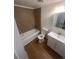 Bathroom featuring a vanity, toilet, tub, and wood-look floors at 1533 S Jamaica St, Aurora, CO 80012