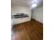 Living room featuring hardwood floors and a kitchen pass-through window at 1533 S Jamaica St, Aurora, CO 80012