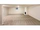 Large finished basement with neutral carpeting and a fireplace at 1772 Robb St, Lakewood, CO 80215