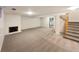 Finished basement featuring a fireplace and access to stairs at 1772 Robb St, Lakewood, CO 80215